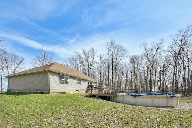21100 Fleckinger Rd, West Mansfield, OH 43358 - exterior space with a yard, a wooden deck, a covered pool, and a shingled roof