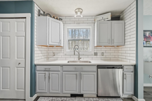 21100 Fleckinger Rd, West Mansfield, OH 43358 - kitchen featuring a textured ceiling, light countertops, decorative backsplash, dishwasher, and a sink