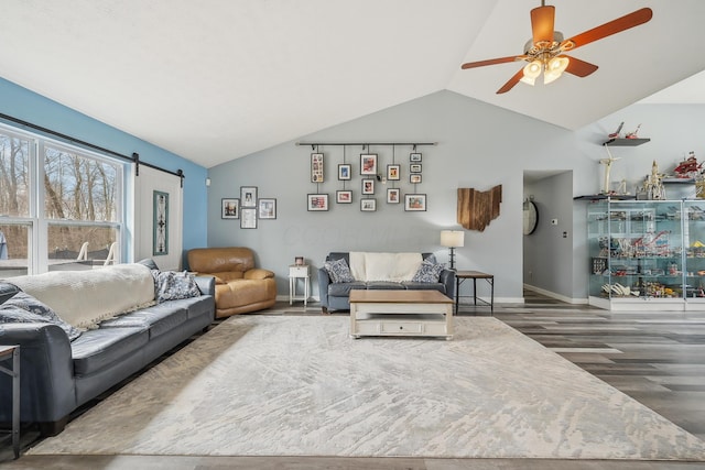 21100 Fleckinger Rd, West Mansfield, OH 43358 - living room with baseboards, a barn door, ceiling fan, vaulted ceiling, and wood finished floors