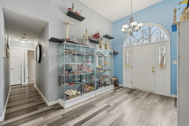 21100 Fleckinger Rd, West Mansfield, OH 43358 - entrance foyer featuring a chandelier, baseboards, and wood finished floors
