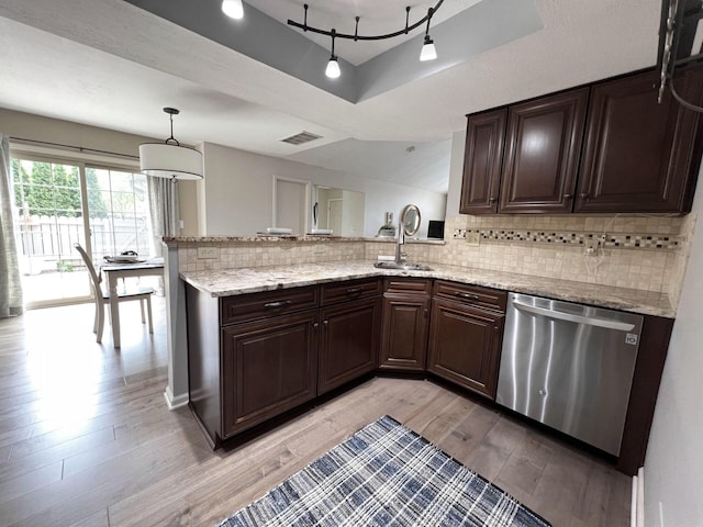 kitchen featuring stainless steel dishwasher, dark brown cabinets, tasteful backsplash, and light wood-style floors