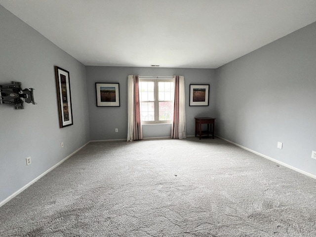 spare room with carpet floors and baseboards