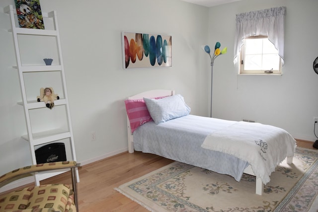bedroom with baseboards and light wood-style flooring