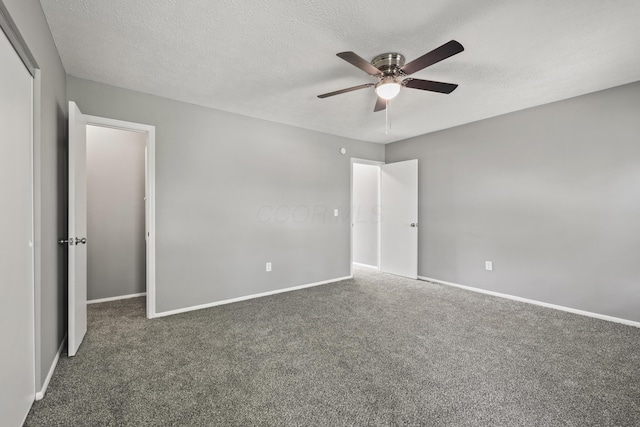 unfurnished bedroom featuring baseboards, carpet flooring, a textured ceiling, and ceiling fan