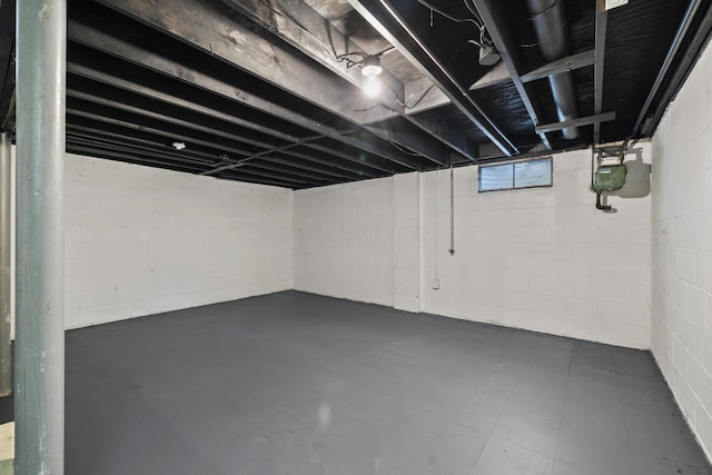 below grade area featuring concrete block wall