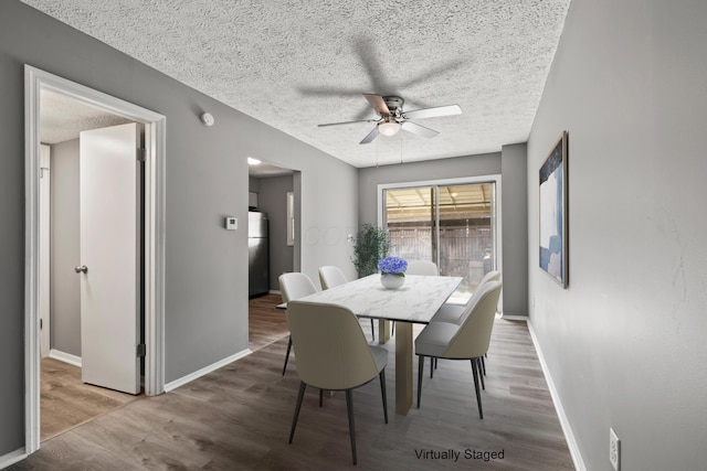 1006 Hardesty Pl W, Columbus, OH 43204 - dining area featuring ceiling fan, a textured ceiling, baseboards, and wood finished floors
