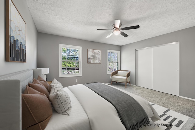 1006 Hardesty Pl W, Columbus, OH 43204 - carpeted bedroom with a closet, a ceiling fan, and a textured ceiling