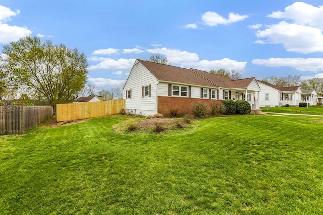 1738 W Chestnut St, Lancaster, OH 43130 - view of side of property with brick siding, fence, and a lawn