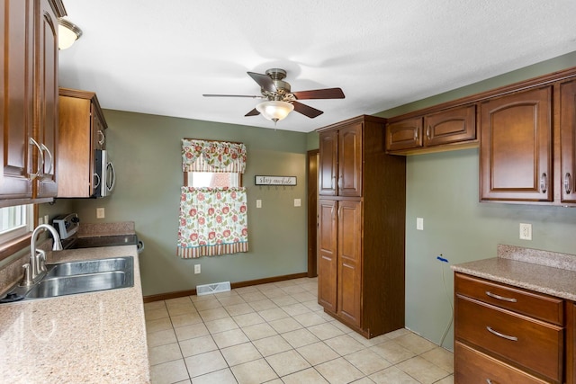 1738 W Chestnut St, Lancaster, OH 43130 - kitchen featuring visible vents, a sink, light countertops, a ceiling fan, and stainless steel microwave