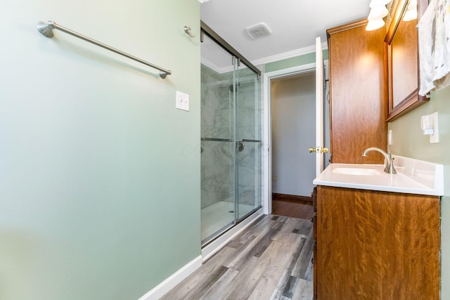 1738 W Chestnut St, Lancaster, OH 43130 - bathroom with baseboards, crown molding, vanity, wood finished floors, and a stall shower