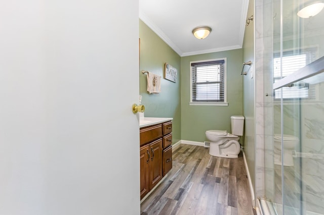 1738 W Chestnut St, Lancaster, OH 43130 - bathroom featuring ornamental molding, toilet, a shower stall, vanity, and wood finished floors
