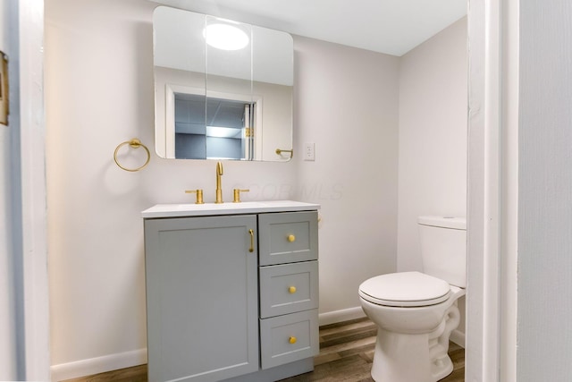 1738 W Chestnut St, Lancaster, OH 43130 - bathroom featuring toilet, wood finished floors, vanity, and baseboards