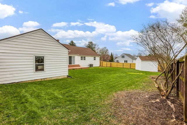 1738 W Chestnut St, Lancaster, OH 43130 - view of yard with an outdoor structure, cooling unit, a fenced backyard, a storage shed, and a deck