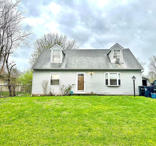 back of property with fence, a yard, and cooling unit
