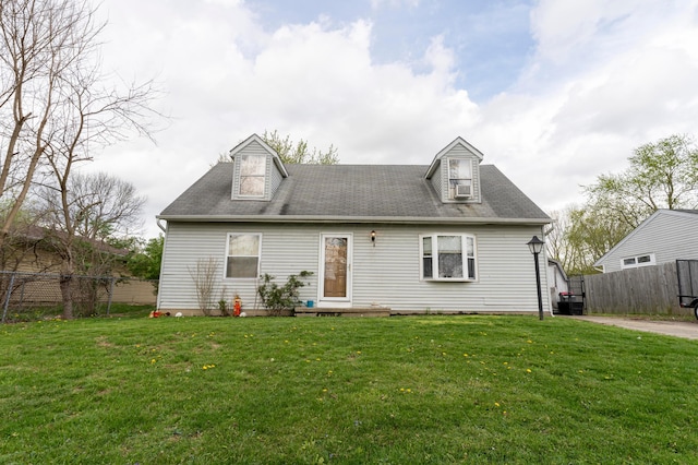 view of front of house with a front yard and fence