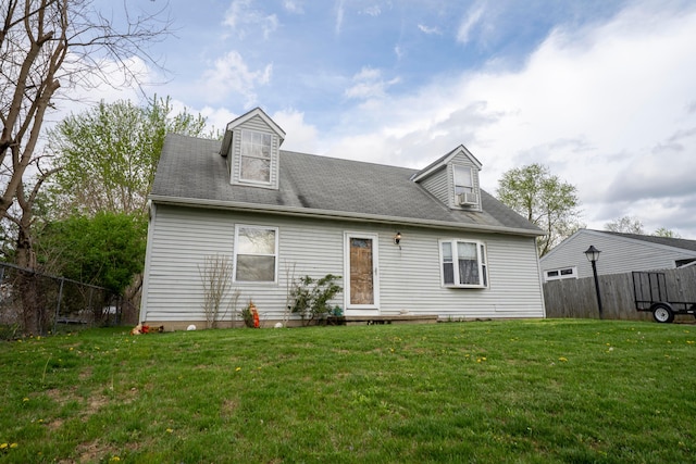 back of house featuring fence and a yard