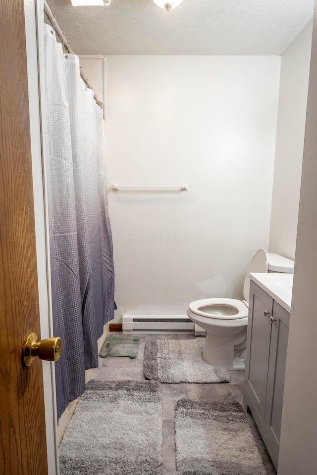 bathroom with baseboard heating, toilet, a shower with curtain, and vanity