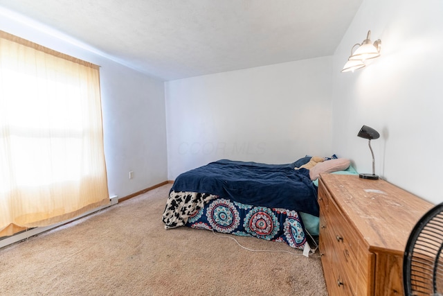 carpeted bedroom featuring baseboards
