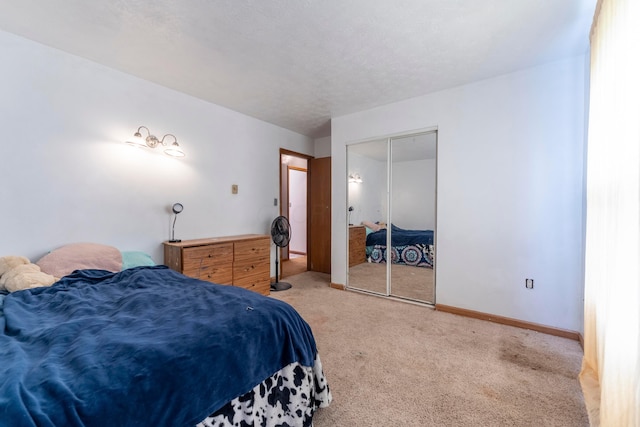 bedroom featuring baseboards, carpet flooring, and a closet