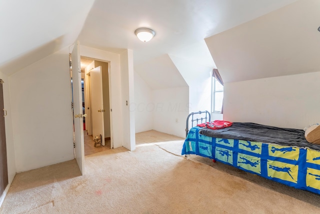 carpeted bedroom with lofted ceiling
