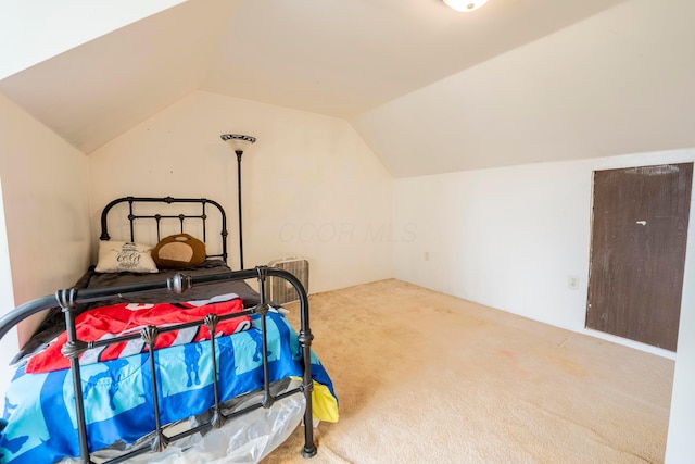 carpeted bedroom with vaulted ceiling