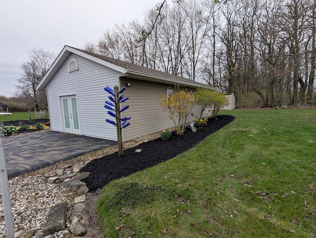 view of home's exterior with a patio, french doors, and a yard