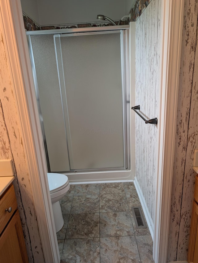 bathroom featuring a shower stall, vanity, and visible vents