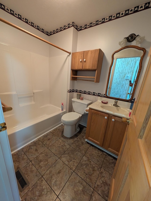 bathroom featuring vanity, tile patterned floors, shower / tub combination, toilet, and visible vents