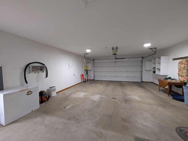 garage with baseboards and a garage door opener