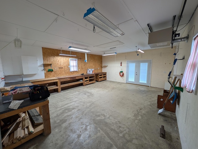 garage featuring french doors and a workshop area