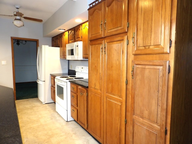 kitchen featuring brown cabinets, dark countertops, white appliances, a ceiling fan, and light floors