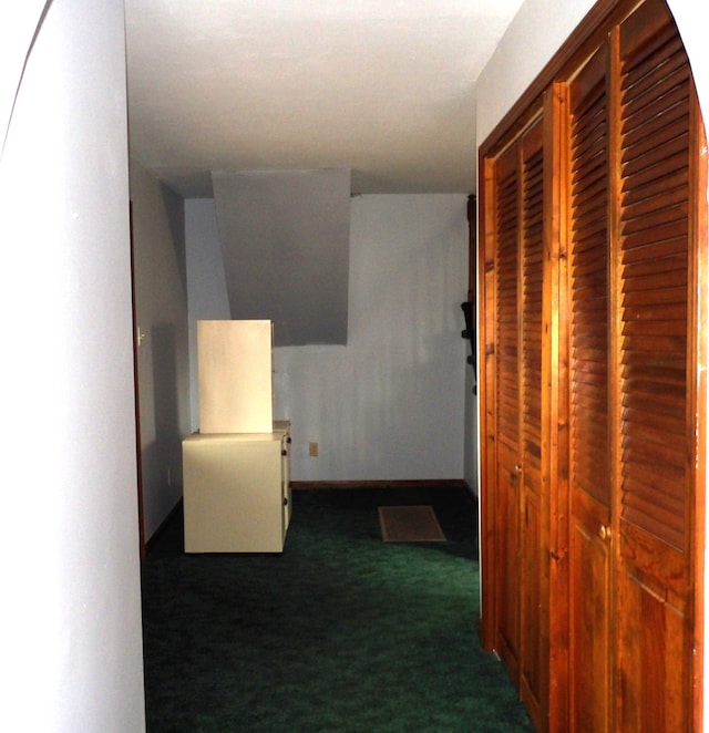 hall with carpet floors and baseboards