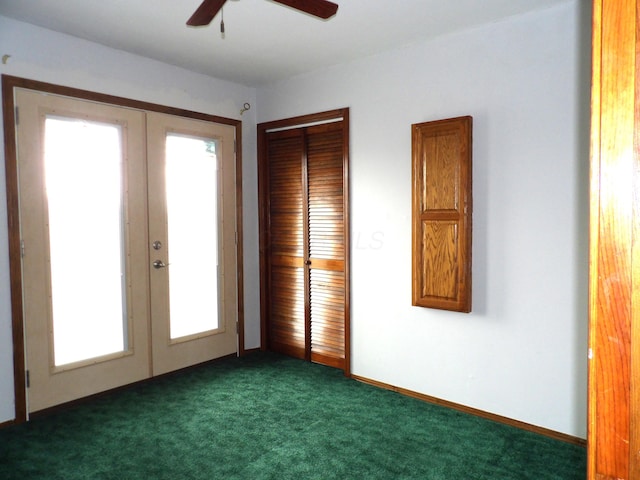 spare room with french doors, baseboards, ceiling fan, and dark carpet