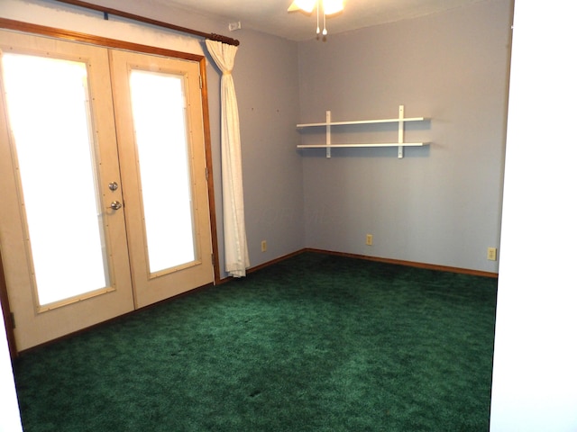 spare room featuring baseboards, french doors, and dark carpet