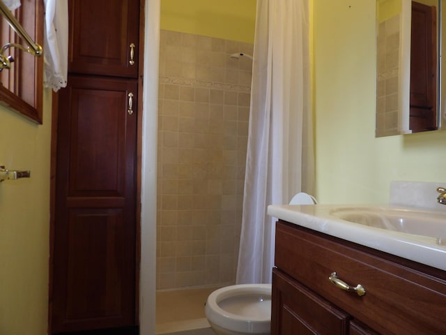 bathroom with a stall shower, toilet, and vanity