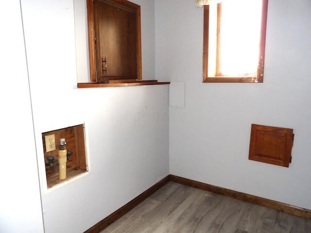empty room with baseboards and light wood finished floors