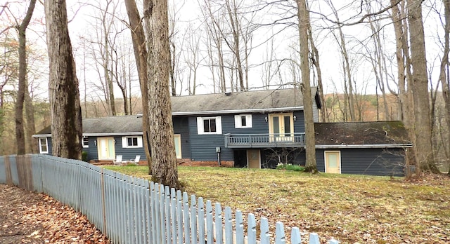 view of front facade with fence and a wooden deck