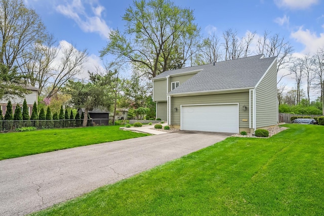view of home's exterior featuring aphalt driveway, fence, and a yard