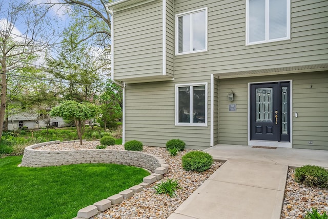 doorway to property with a yard