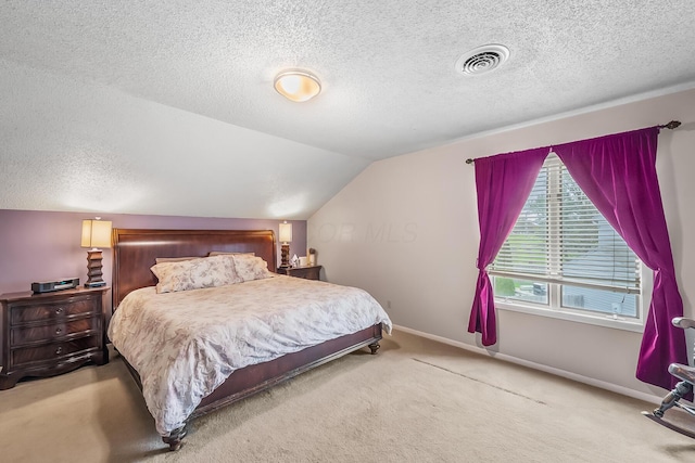 carpeted bedroom featuring baseboards, vaulted ceiling, a textured ceiling, and visible vents