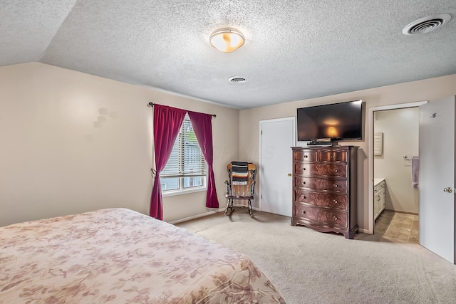 bedroom featuring visible vents, a textured ceiling, baseboards, and light colored carpet