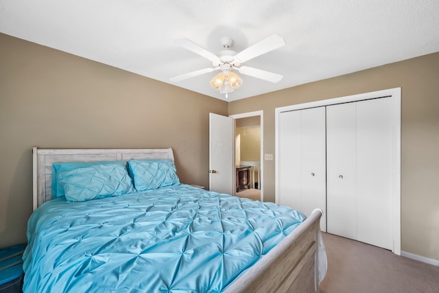 carpeted bedroom with a closet, baseboards, and ceiling fan