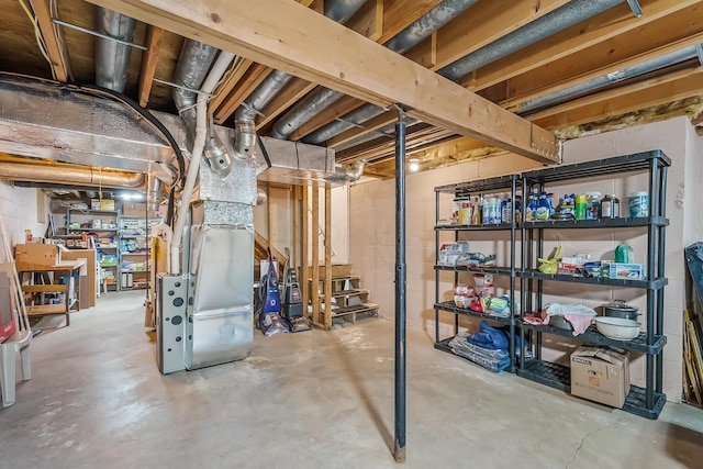 unfinished below grade area featuring heating unit