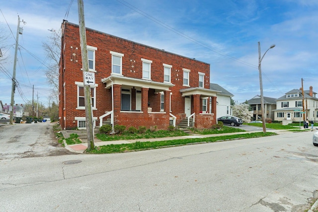 view of property featuring brick siding and a residential view