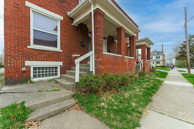 view of property exterior featuring brick siding