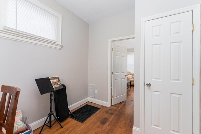 office area with visible vents, baseboards, and wood finished floors