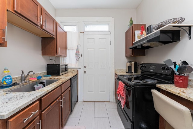 kitchen with light stone counters, light tile patterned flooring, black appliances, under cabinet range hood, and a sink