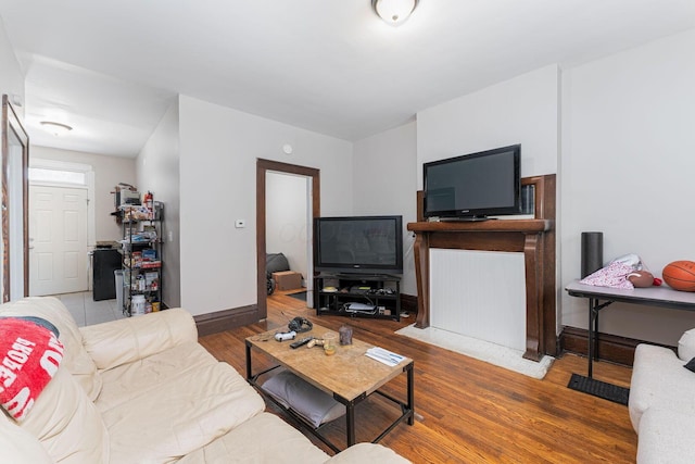 living room with baseboards and wood finished floors