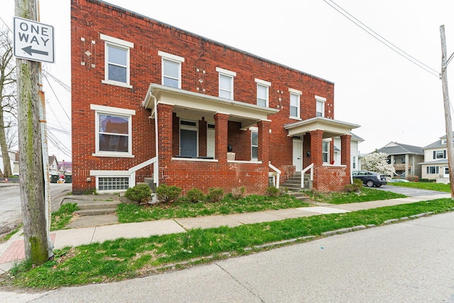 townhome / multi-family property featuring brick siding