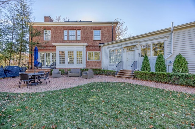 6920 Clivdon Mews, New Albany, OH 43054 - back of property featuring a patio area, brick siding, a chimney, and a lawn